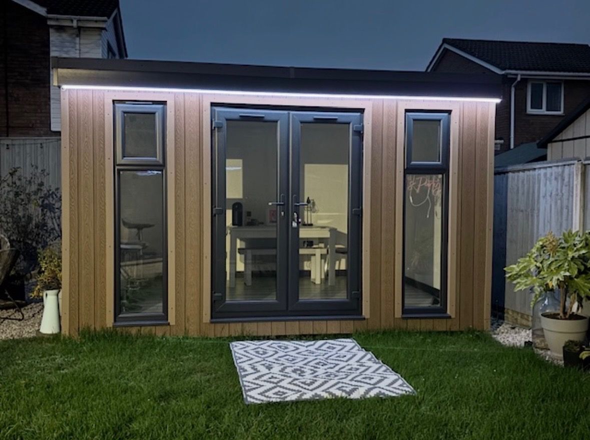 Timber-clad garden room with French doors and LED lighting